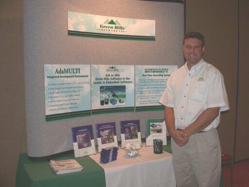 Kevin Gallagher in front of the Green Hills Software booth