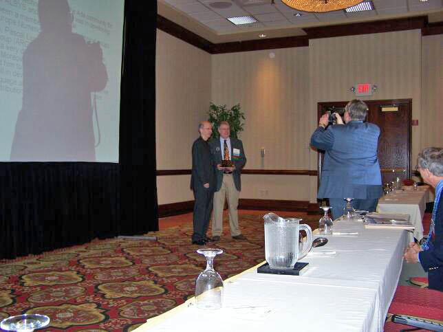 John McCormick presents the Outstanding Ada Community Contributions Award to Pascal Leroy