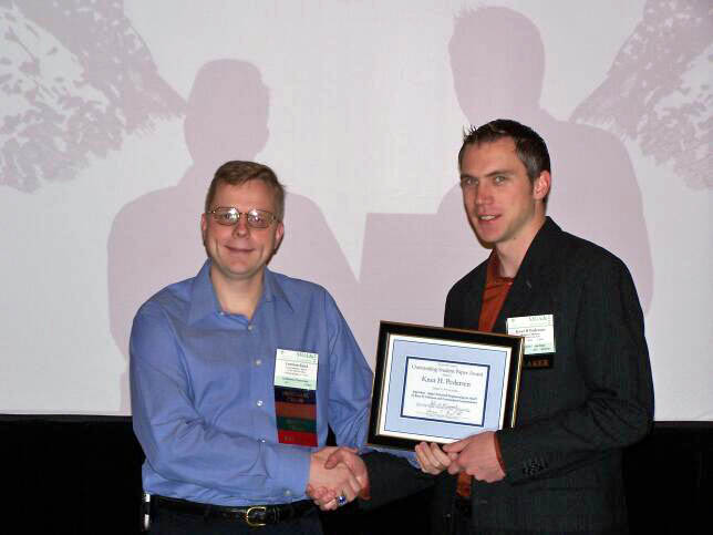 Leemon Baird presents the Best Student Paper Award to Knut Pedersen