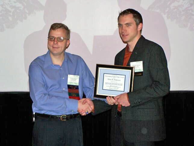 Leemon Baird presents the Best Student Paper Award to Knut Pedersen
