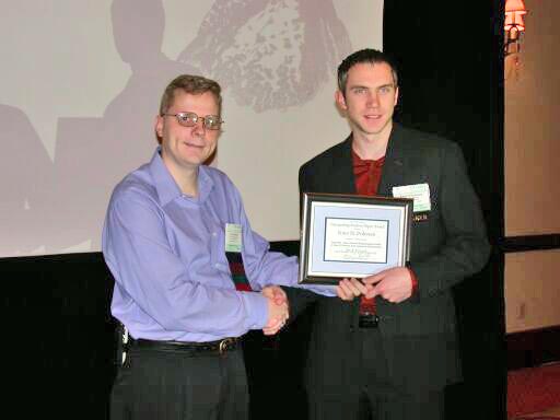 Leemon Baird presents the Best Student Paper Award to Knut Pedersen