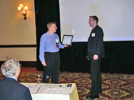 Leemon Baird presents the Best Student Paper Award to Knut Pedersen