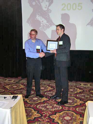 Leemon Baird presents the Best Student Paper Award to Knut Pedersen