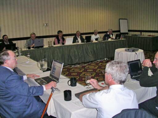 In the foreground, Currie Colket and Greg Gicca (ASIS Editor)